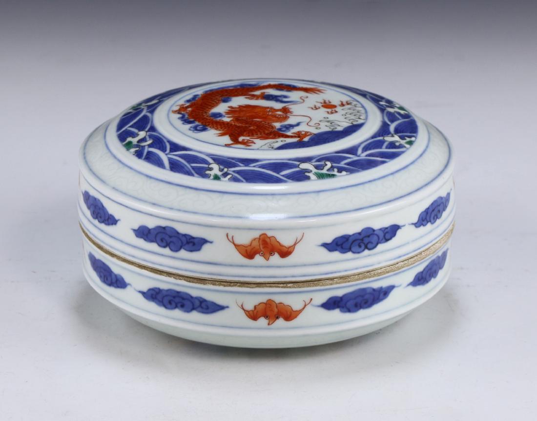 A CHINESE ANTIQUE FAMILLE ROSE LIDDED PORCELAIN CASE: A Chinese Antique Famille Rose Lidded Porcelain Case: Of Cylindrical Form, Cover Finely Painted With A Swirling Dragon Chasing A Flaming Pearl Amid Scrolling Clouds, Case Sides Painted With Orange Bat