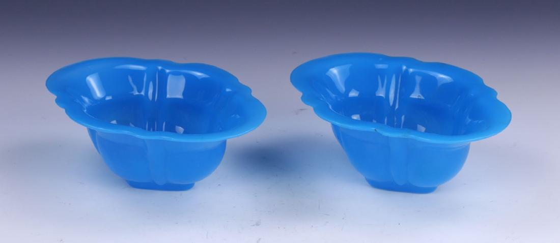 PAIR CHINESE ANTIQUE BLUE PEKING GLASS BOWLS: Pair Chinese Antique Blue Peking Glass Bowls: Of Ovoid Form, Rising From Bases Rested On Low Feet To Lipped Rims, The Semi Translucent Glass Of Consistent Vibrant Blue Tones; Size: L: 6-1/4" (15.88cm)