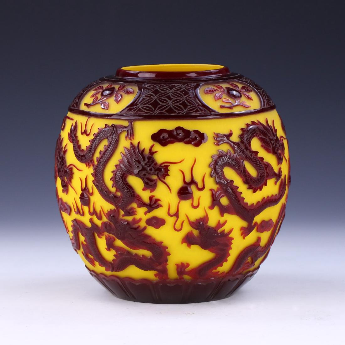 A CHINESE ANTIQUE OVERLAY PEKING GLASS JAR: A Chinese Antique Overlay Peking Glass Jar: Of Globular Form, Finely Carved Around The Body With Dragons Chasing Flaming Pearls Amid Scrolling Clouds; Size: H: 7-1/2" (19.05cm)