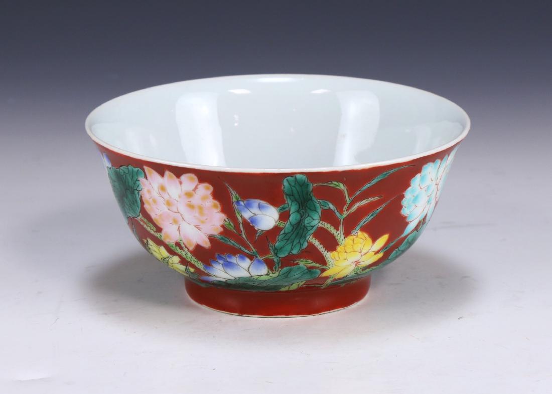 A CHINESE ANTIQUE FAMILLE ROSE PORCELAIN BOWL: A Chinese Antique Famille Rose Porcelain Bowl: Well Potted And Of Rising Sides, Exterior Body Finely Painted With Sprouting Lotus Blossoms Of Mixed Tones And Large Lily Pads Amid An Ox Blood Glazed Gr
