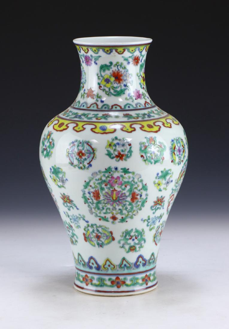 A CHINESE ANTIQUE FAMILLE ROSE PORCELAIN VASE: A Chinese Antique Famille Rose Porcelain Vase: Of Bulbous Form, Body Finely Painted With Medallions Comprised Of Sprouting Blossoms Of Mixed Tones And Plant Stalks Amid Swirling Stems, Six Character Q