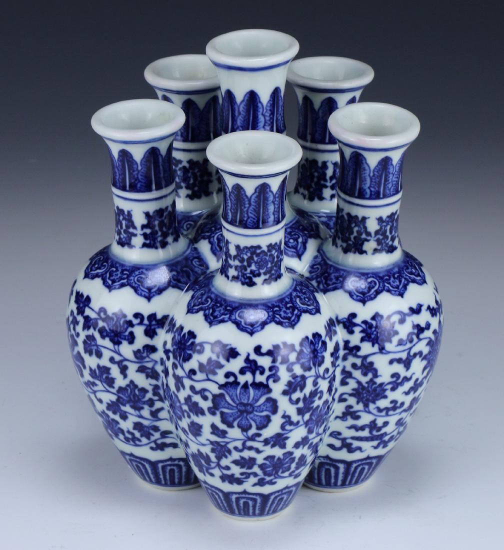 A CHINESE ANTIQUE SIX HOLE BLUE & WHITE PORCELAIN VASE: 清乾隆青花瓜瓞綿綿六孔花插 A Chinese Antique Six Hole Blue & White Porcelain Vase: intricately Designed As Six Vases Molde