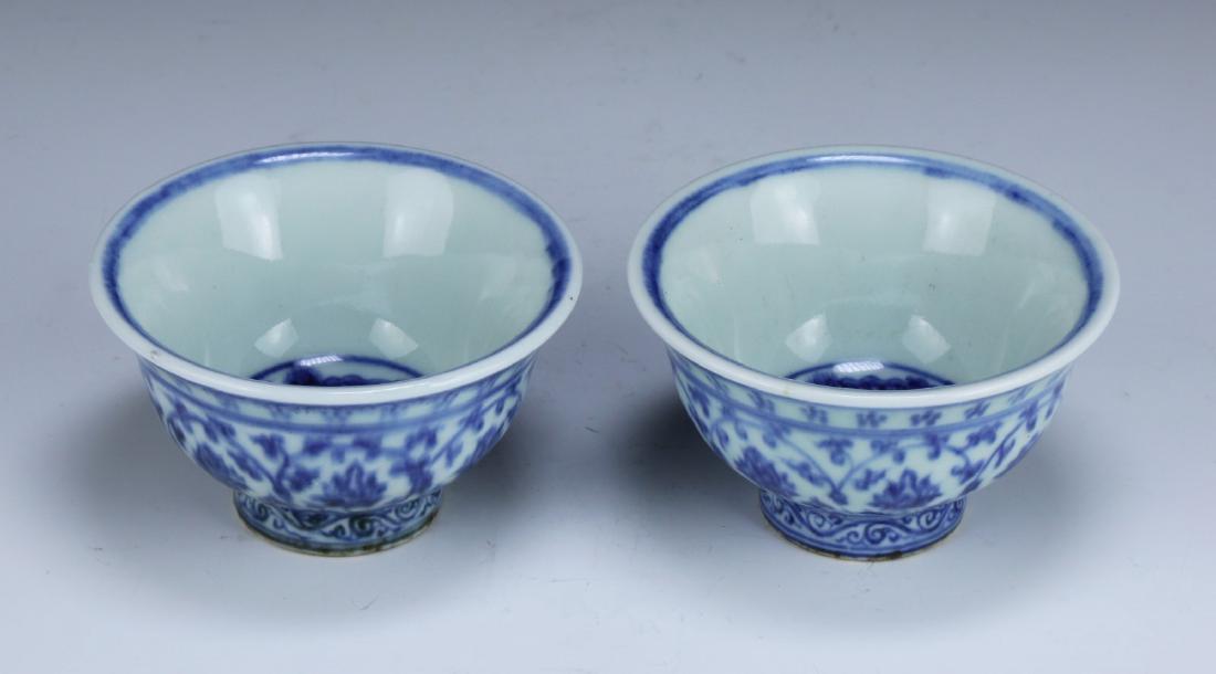 PAIR CHINESE ANTIQUE BLUE & WHITE PORCELAIN CUPS: Pair Chinese Antique Blue & White Porcelain Cups: Of Rising Sides, Each Body Finely Painted With Blooming Flowers Amid Long Stems; Size: D: 3-1/2" (8.89cm) [Each]