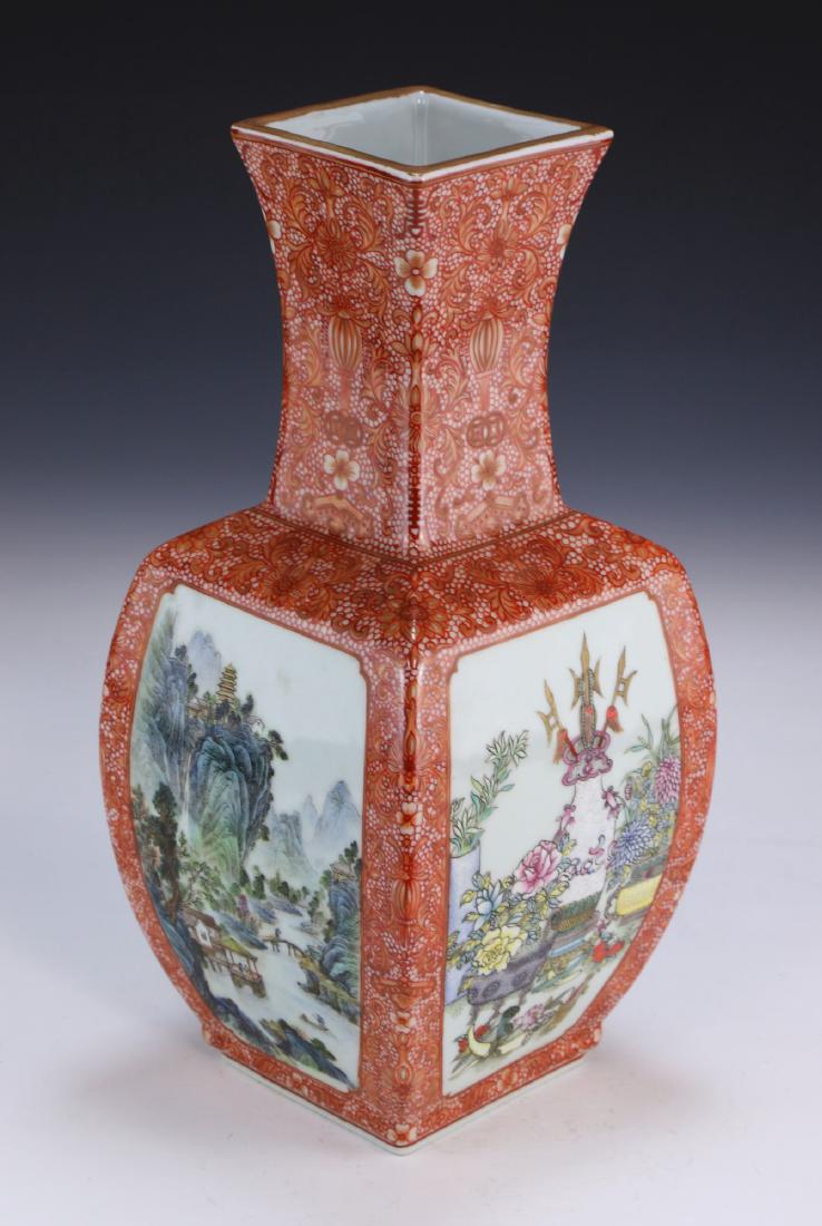 A CHINESE ANTIQUE FAMILLE ROSE PORCELAIN VASE: 乾隆款礬紅地五彩開窗方瓶A Chinese Antique Famille Rose Porcelain Vase: Of Square Ovoid Form With A Square Neck And Rim, The Body