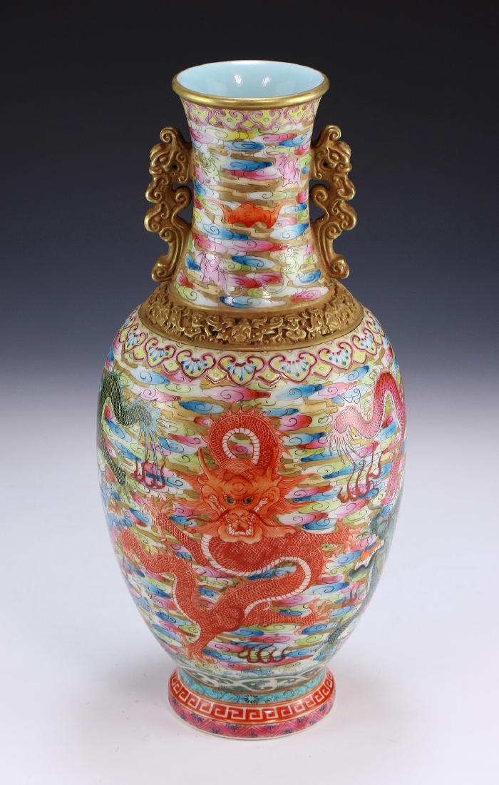 A CHINESE ANTIQUE FAMILLE ROSE PORCELAIN VASE: A Chinese Antique Famille Rose Porcelain Vase: Of Ovoid Form, The Body Elaborately Painted With Various Dragons And Bats Flying Amid Flames And Vibrant Colored Clouds, Flanked On Each Side Of The Neck