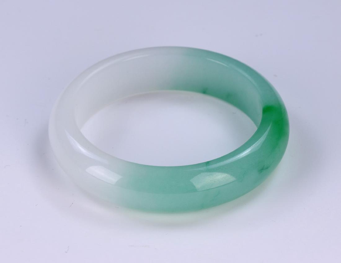 A SEMI-TRANSLUCENT JADEITE BANGLE (1 of 2)