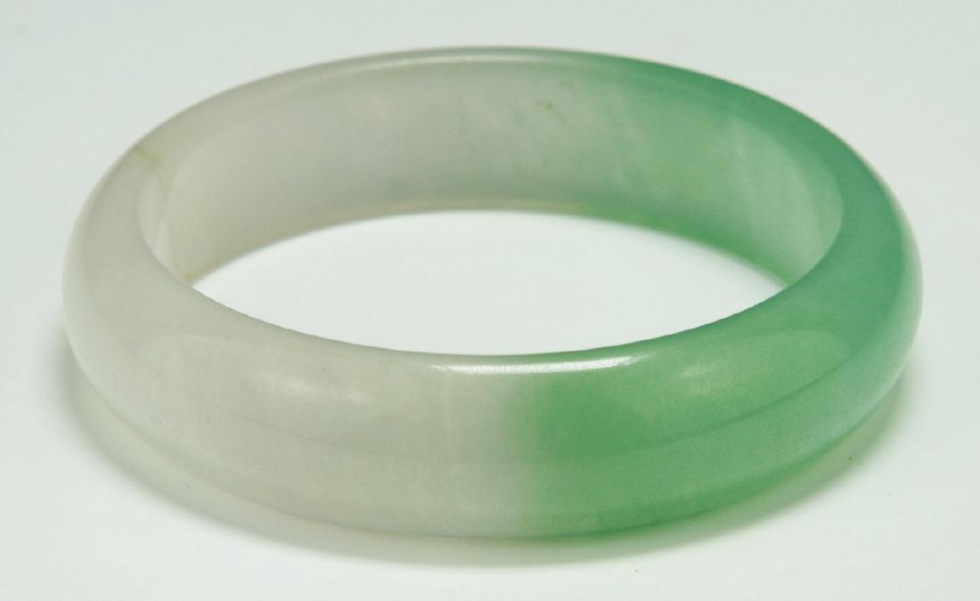 A HIGHLY TRANSLUCENT JADEITE BANGLE (1 of 3)