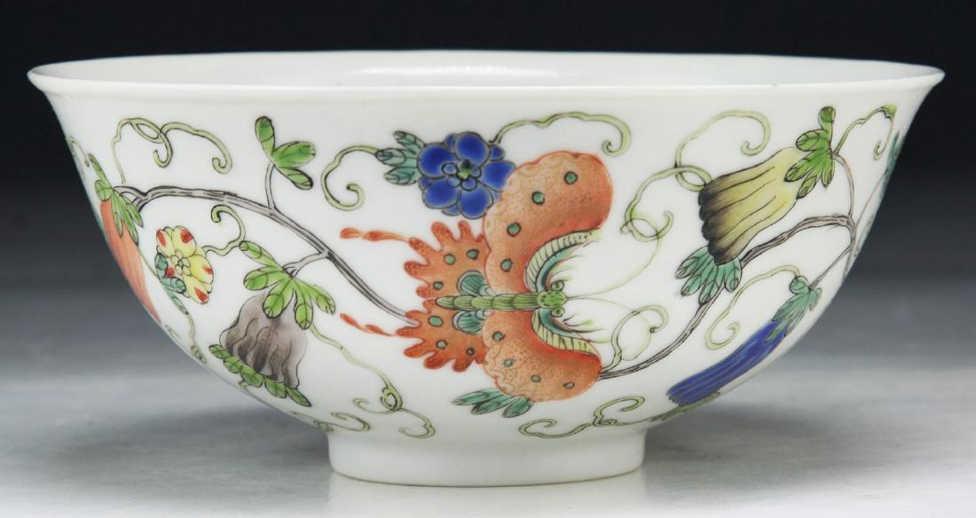 A CHINESE ANTIQUE FAMILLE ROSE PORCELAIN BOWL: A Chinese Antique Famille Rose Porcelain Bowl: Of Rounded Sides, Exterior Of The Bowl Finely Painted With Three Butterfly Figures Flying Amid Blooming Flowers Of Blue, Orange, And Yellow Tones; Size: