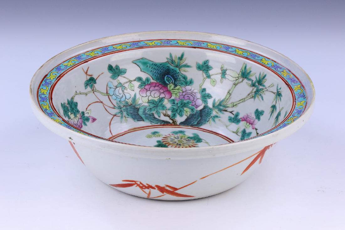 A CHINESE ANTIQUE FAMILLE ROSE PORCELAIN BOWL: A Chinese Antique Famille Rose Porcelain Bowl: Finely Painted With Birds Resting in A Nest, Tucked in Between Branches And Sprouting Wildlife; Size: D: 11-1/2" (29.21cm)