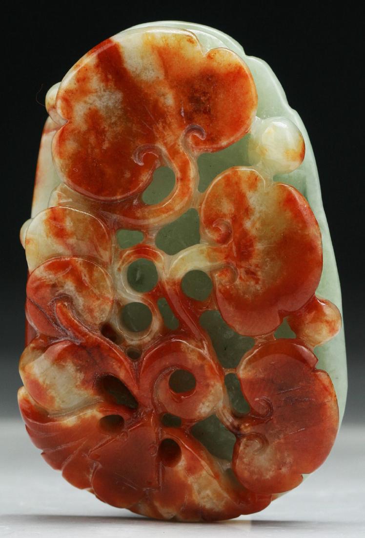 A CHINESE CARVED RED JADEITE PENDANT (1 of 2)