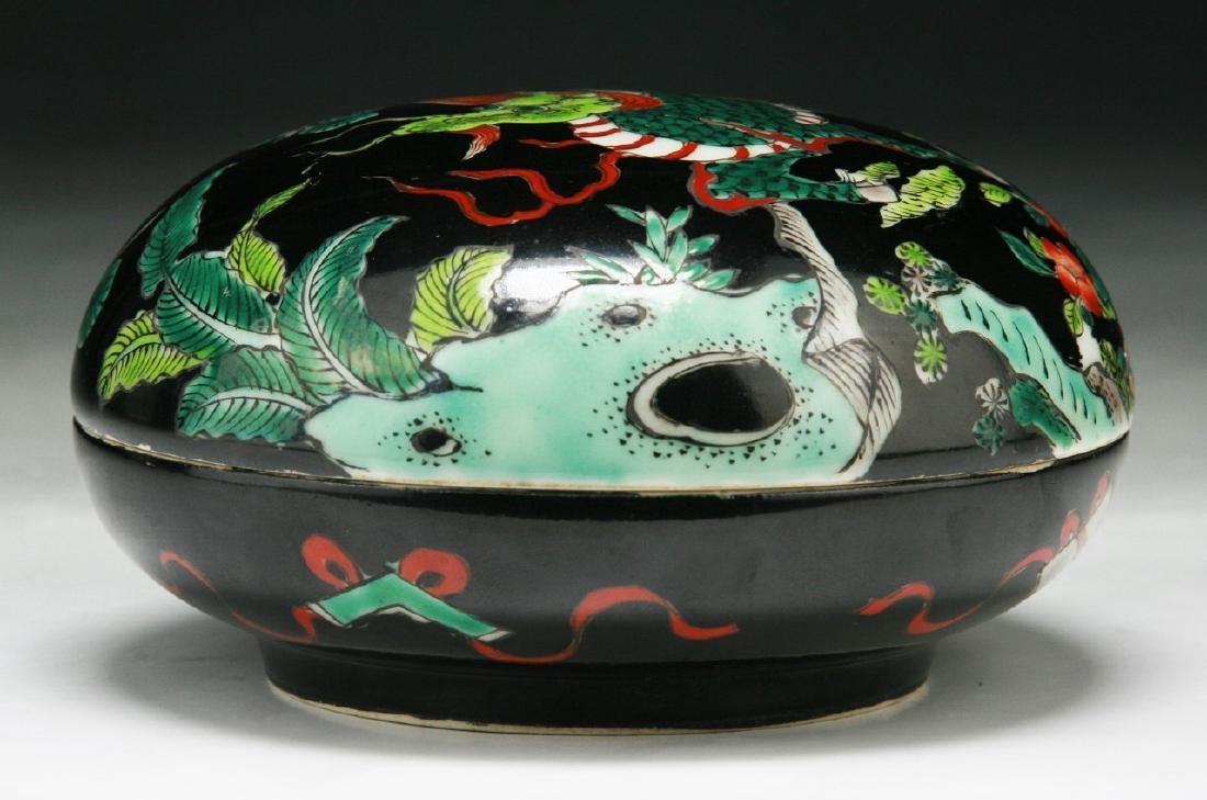 A CHINESE FAMILLE VERTE LIDDED INK CASE: A Chinese Famille Verte Lidded ink Case: Well Potted With Rounded Sides, Lid Finely Painted With A Qilin Dragon Amid Rockery And Sprouting Pine Trees, Six Character Kangxi Mark On The Base in Iron Red