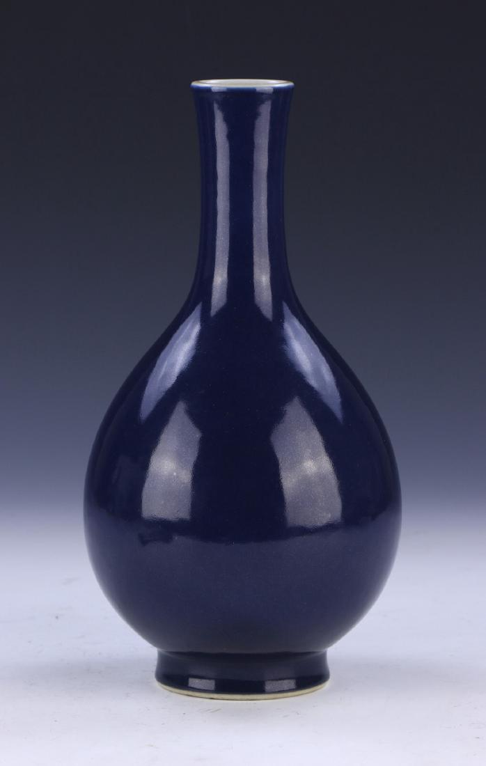 A CHINESE ANTIQUE BLUE GLAZED PORCELAIN VASE: A Chinese Antique Blue Glazed Porcelain Vase: Well Potted And Of Pear Shape, Rising From A Base Rested On Low Feet To A Slim Neck And Splayed Rim, Body Evenly Coated in A Deep Blue Glaze, Six Characte