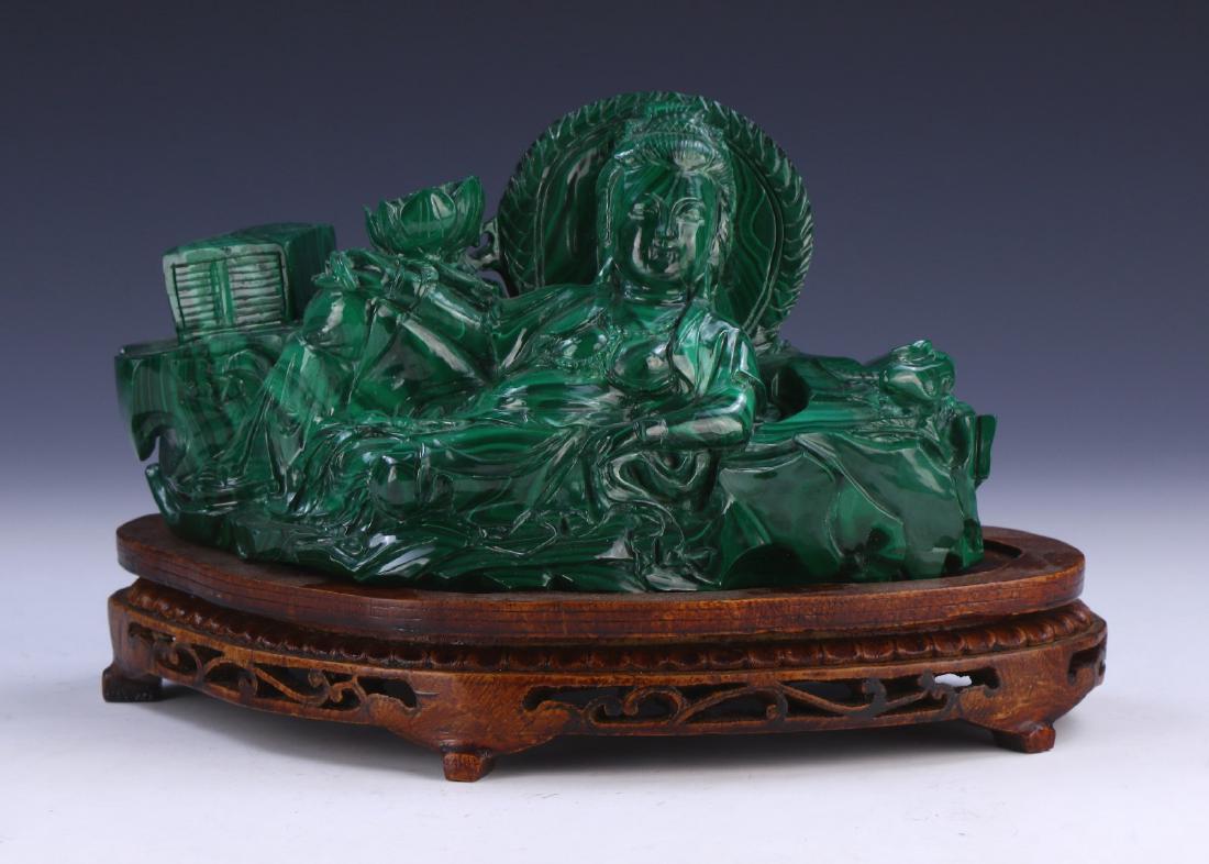A CHINESE MALACHITE CARVED GUANYIN: A Chinese Malachite Carved Guanyin: Skillfully Carved As Guanyin in A Resting Position Amid Rockery, Flanked By A Sprouting Lotus Blossom And Scholarly Text, Draped in Loose Traditional Robes, Present