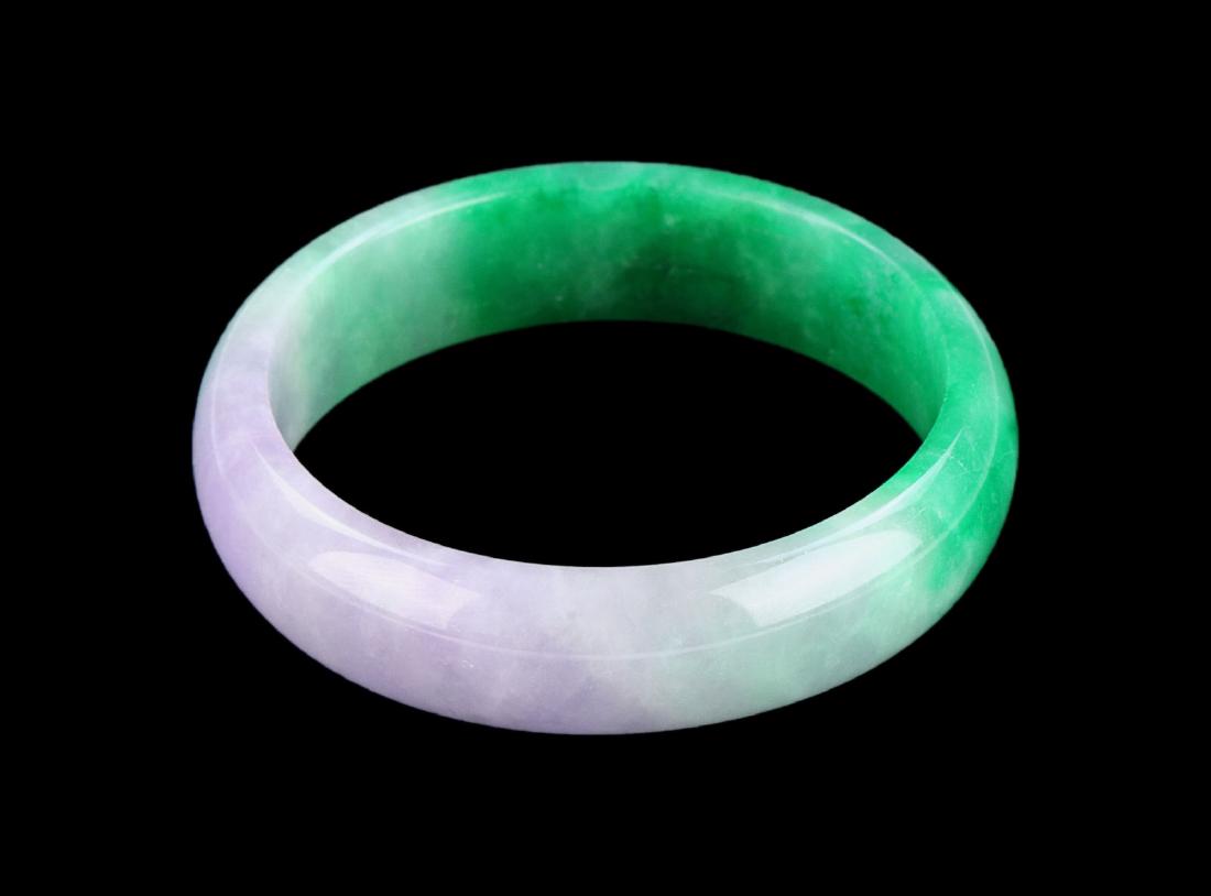 A TWO-COLOR JADEITE BANGLE (1 of 2)