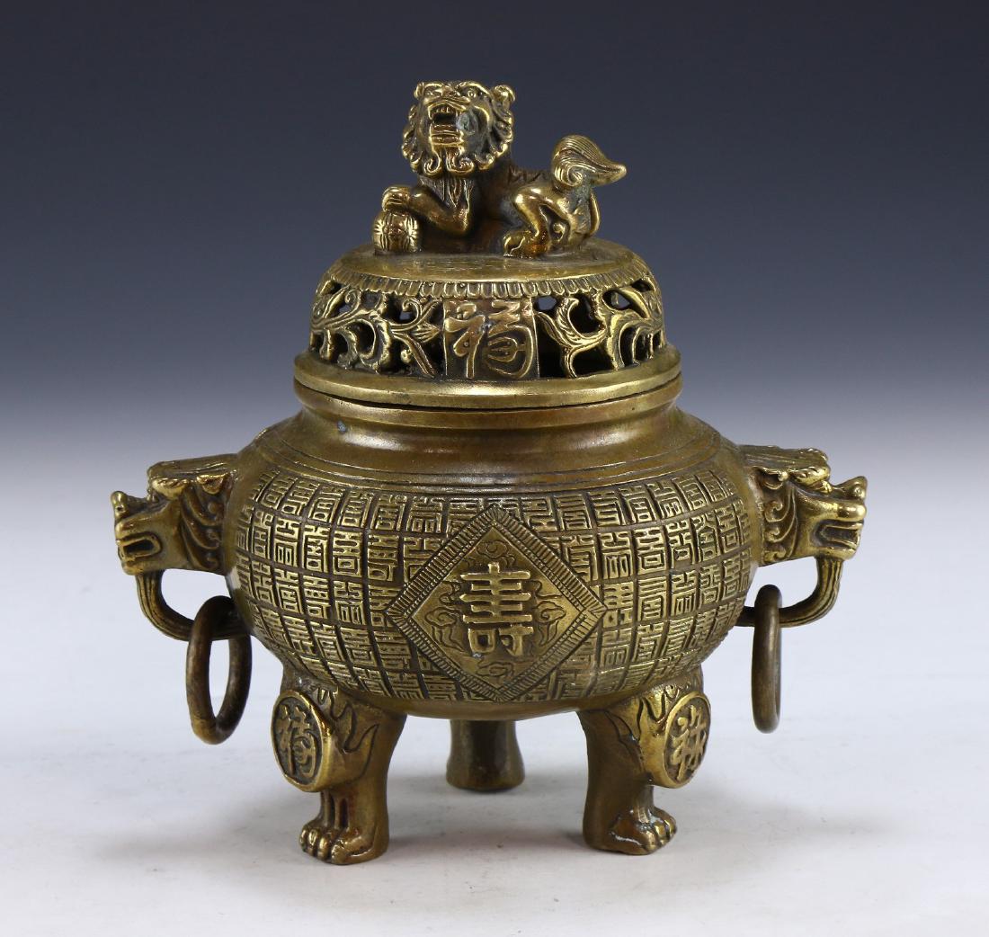 A CHINESE ANTIQUE LIDDED TRIPOD BRONZE CENSER: A Chinese Antique Lidded Tripod Bronze Censer: Of Compressed Globular Form, Rising From Three Thick Feet To A Domed Openwork Lid Topped With A Lion Dog Form Finial, Censer Shoulders Finely Cast With D