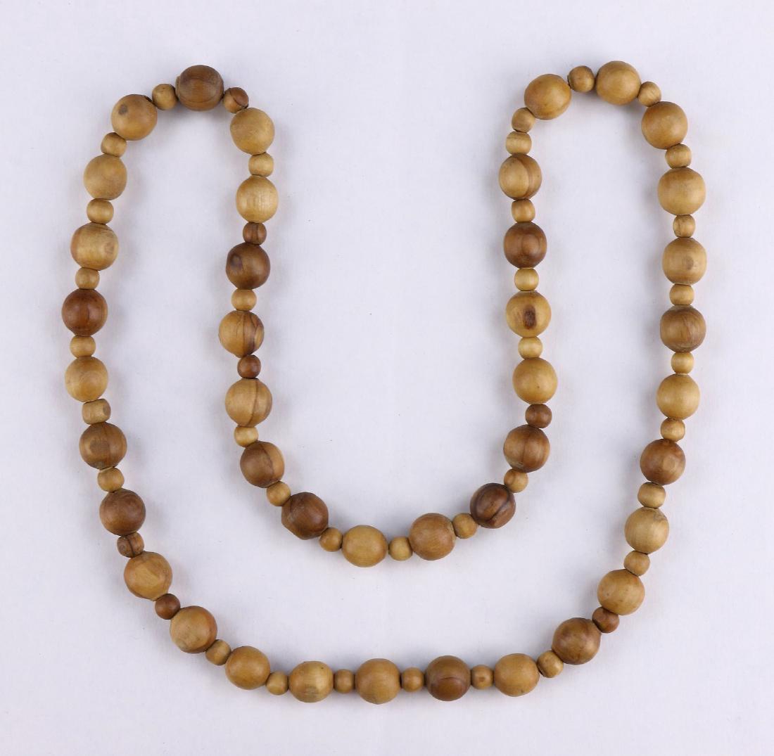 AN AGARWOOD BEADED NECKLACE: 沉香木項鏈 An Agarwood Beaded Necklace: Each Bead Finely Carved in A Circular Form, The Wood Of Light To Dark Brown Tones; Size: L: 29" (73.66cm); [Bead] D: 12mm