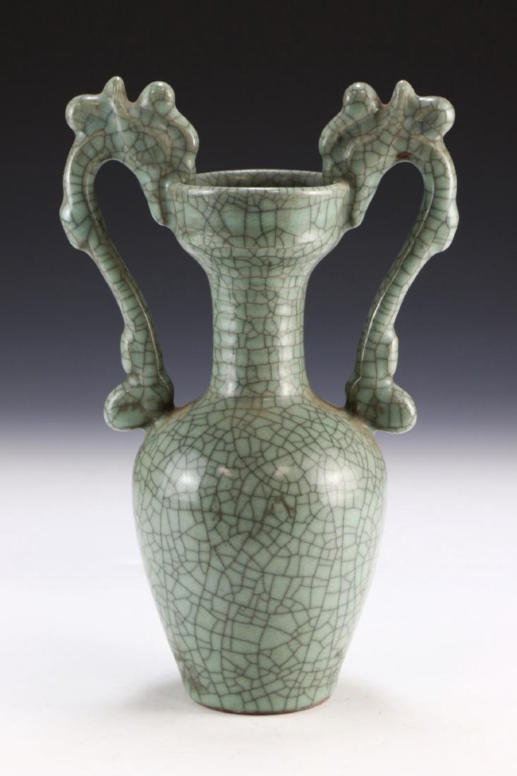 A Chinese Antique Celadon Glazed Porcelain Vase: A Chinese Antique Celadon Glazed Porcelain Vase: Of Shouldered Form, With A Slim And Cylindrical Neck Rising To An Outwardly Flared Rim, Each Side Flanked By A Long Dragon Form Handle, Body With A Cra