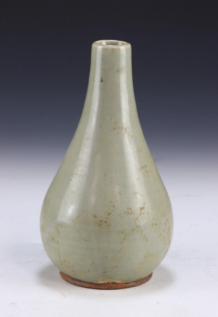 A CHINESE ANTIQUE CELADON GLAZED PORCELAIN VASE: A Chinese Antique Celadon Glazed Porcelain Vase: Of Pear Shape, Rising To A Cylindrical Neck And Flat Rim, Body Evenly Coated in A Medium Celadon Tone; Size: H: 7" (17.78cm)