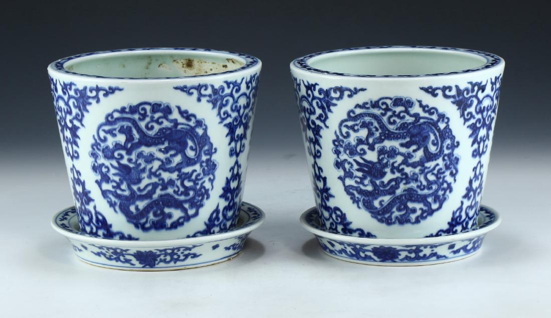 PAIR CHINESE ANTIQUE BLUE & WHITE PORCELAIN PLANTERS: Pair Chinese Antique Blue & White Porcelain Planters: Well Potted And Of Cylindrical Form, Exterior Bodies Finely Painted With Swirling Dragon Scene Panels, Each Amid Thick Curling Stems And Sprouting