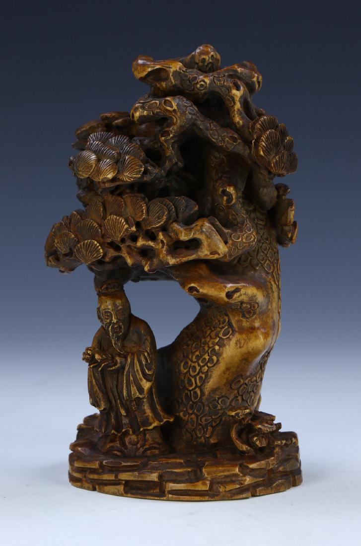 A CHINESE ANTIQUE HUANGYANGMU BOXWOOD STATUE: 黃楊木雕松樹老人擺件 A CHINESE ANTIQUE HUANGYANGMU BOXWOOD STATUE: Finely Carved As A Figure Standing Beneath A Large Pine Tree, Shown Risin