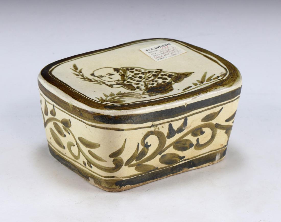 A CHINESE ANTIQUE POLYCHROME PORCELAIN PILLOW: A Chinese Antique Polychrome Porcelain Pillow: Of Squared Form, Headrest Finely Painted With A Figure At Rest Amid A Courtyard, Pillow Sides Painted With Continuous Swirling Stems; Size: L: 6-1/4" (15