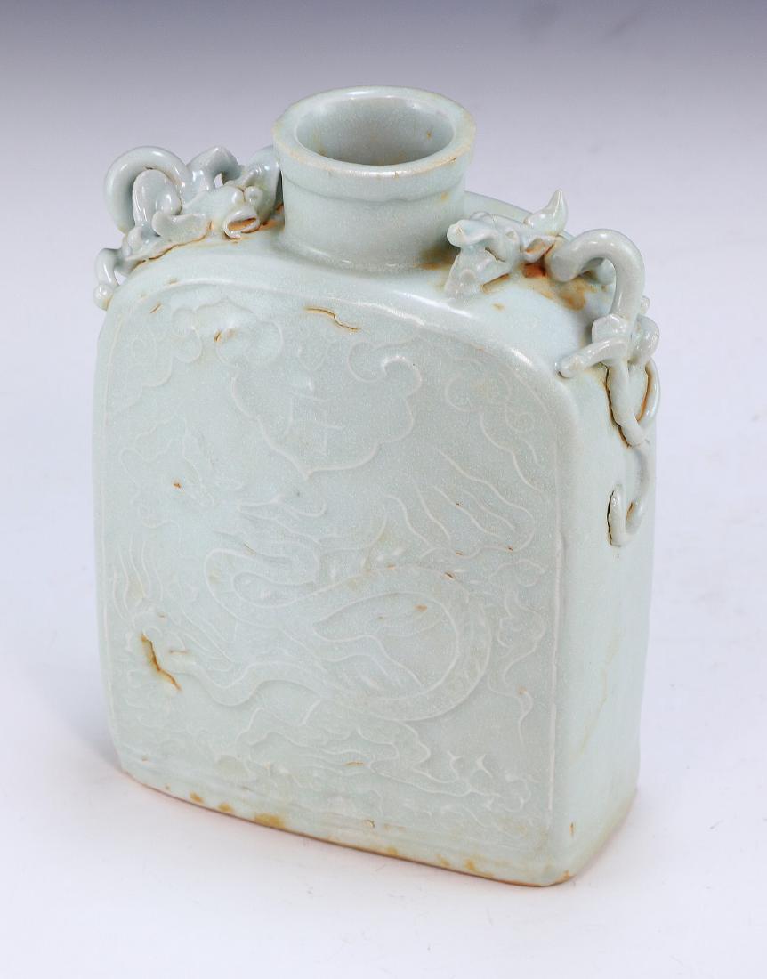 A CHINESE ANTIQUE CELADON GLAZED PORCELAIN PITCHER: A Chinese Antique Celadon Glazed Porcelain Pitcher: Of Rectangular Form, Cylindrical Neck Flanked On Each Side By Chi Dragon Form Handles, Body Finely Painted With Swirling Dragon Scenes; Size: H: 6-1
