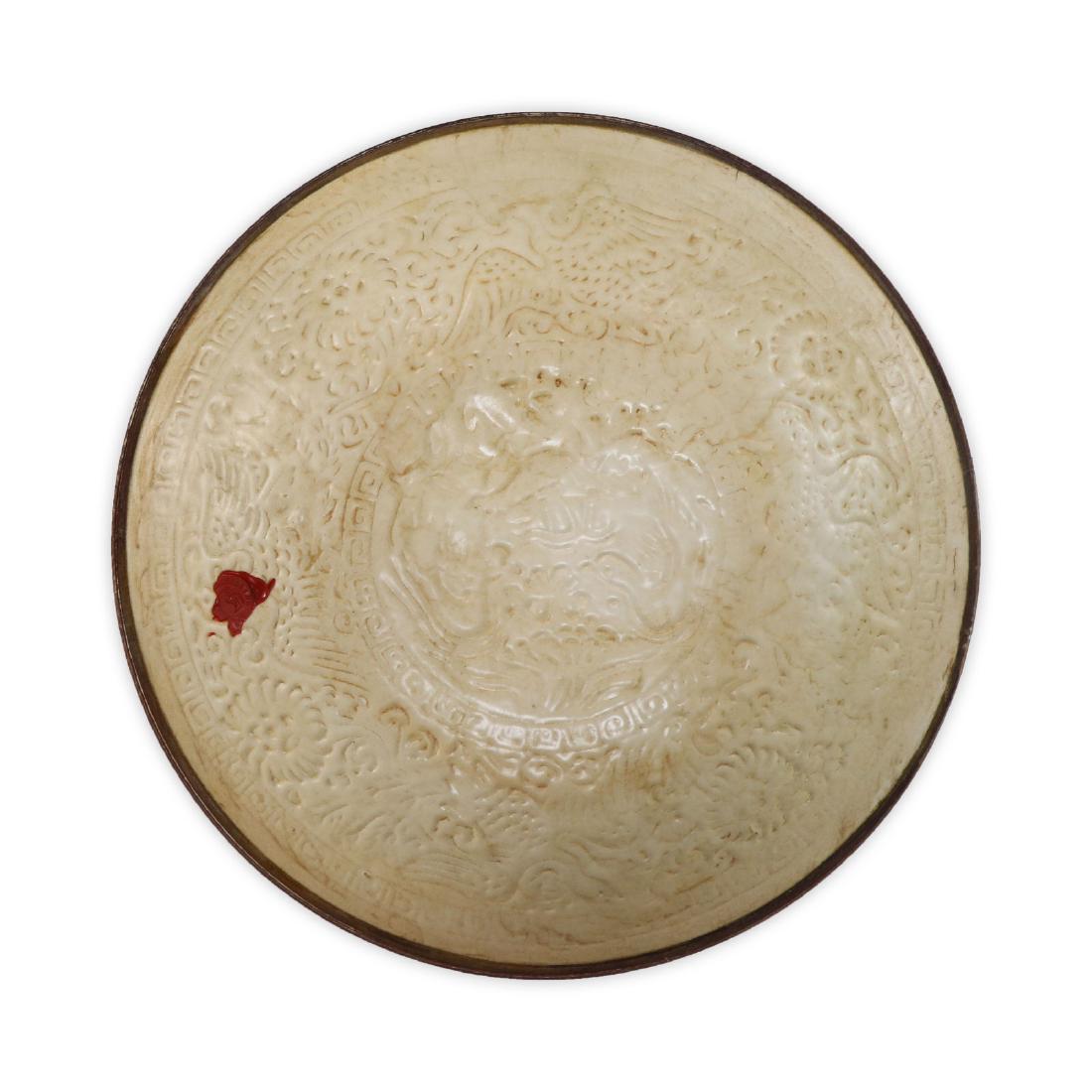 A CHINESE ANTIQUE DINGYAO INCISED PORCELAIN BOWL: A Chinese Antique Dingyao incised Porcelain Bowl: Finely Potted With Deep, Rounded Sides Rising From A Flat Base To A Lipped Rim, interior Freely Carved With Bird Figures Amid Blooming Flowers And Geo