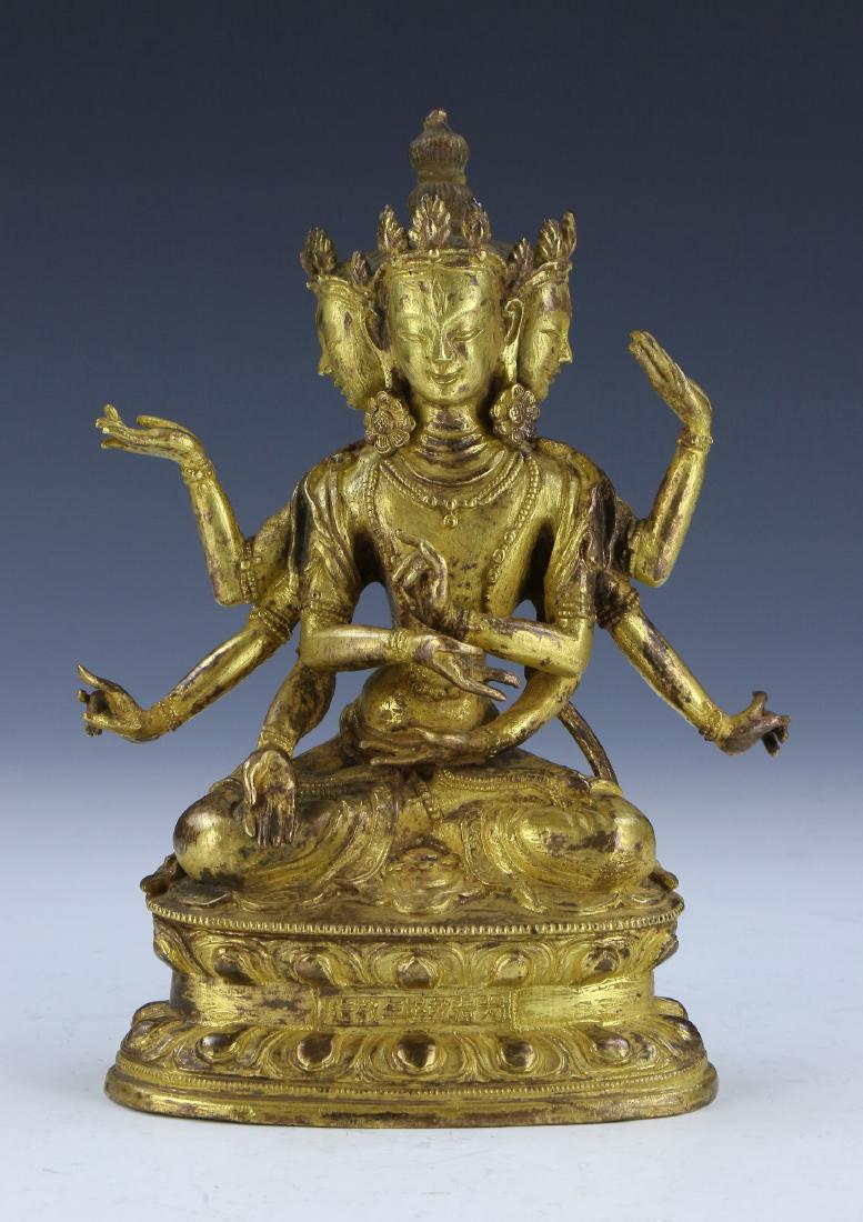 A CHINESE GILT BRONZE FIGURE OF GUANYIN WITH THREE FACE (1 of 10)