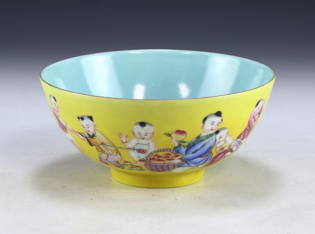 A CHINESE ANTIQUE FAMILLE ROSE PORCELAIN BOWL: A Chinese Antique Famille Rose Porcelain Bowl: The Exterior Finely Painted With Children On A Yellow Glazed Ground, The interior Also With Two Children On A Turquoise Ground, The Base With A Six Chara