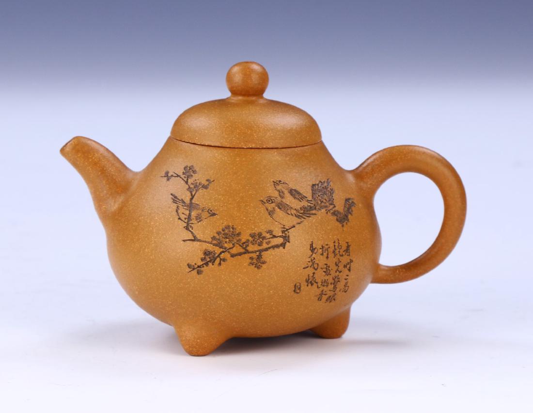 A CHINESE YIXING ZISHA TEAPOT: A Chinese Yixing Zisha Teapot; Size: L: 4-1/2" (11.43cm)