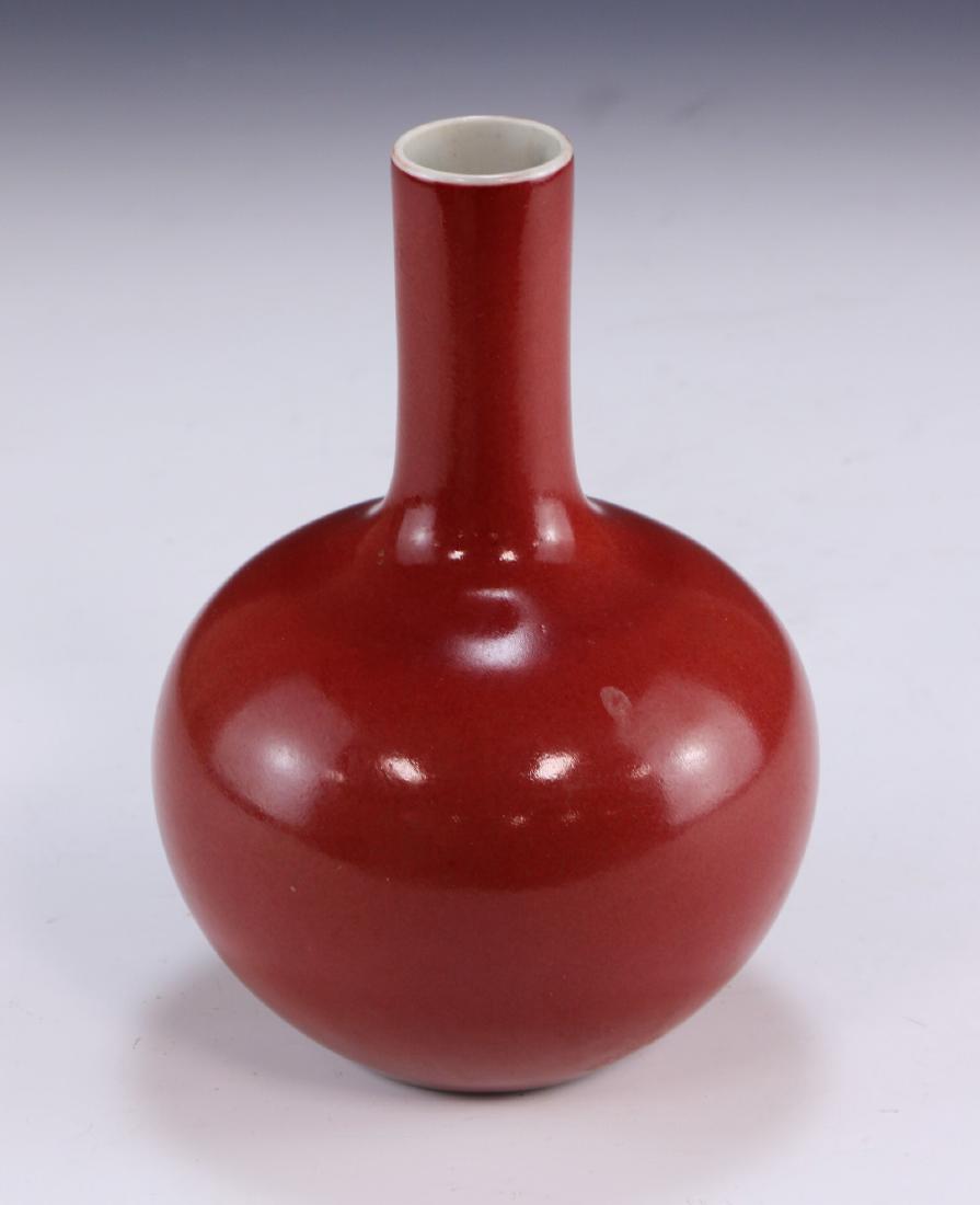A Chinese Antique Ox-Blood Porcelain Vase: A Chinese Antique Ox-Blood Porcelain Vase: Of Globular Form, With A Long And Skinny Neck Of Cylindrical Form; Size: H: 7-1/2" (19. 05cm)
