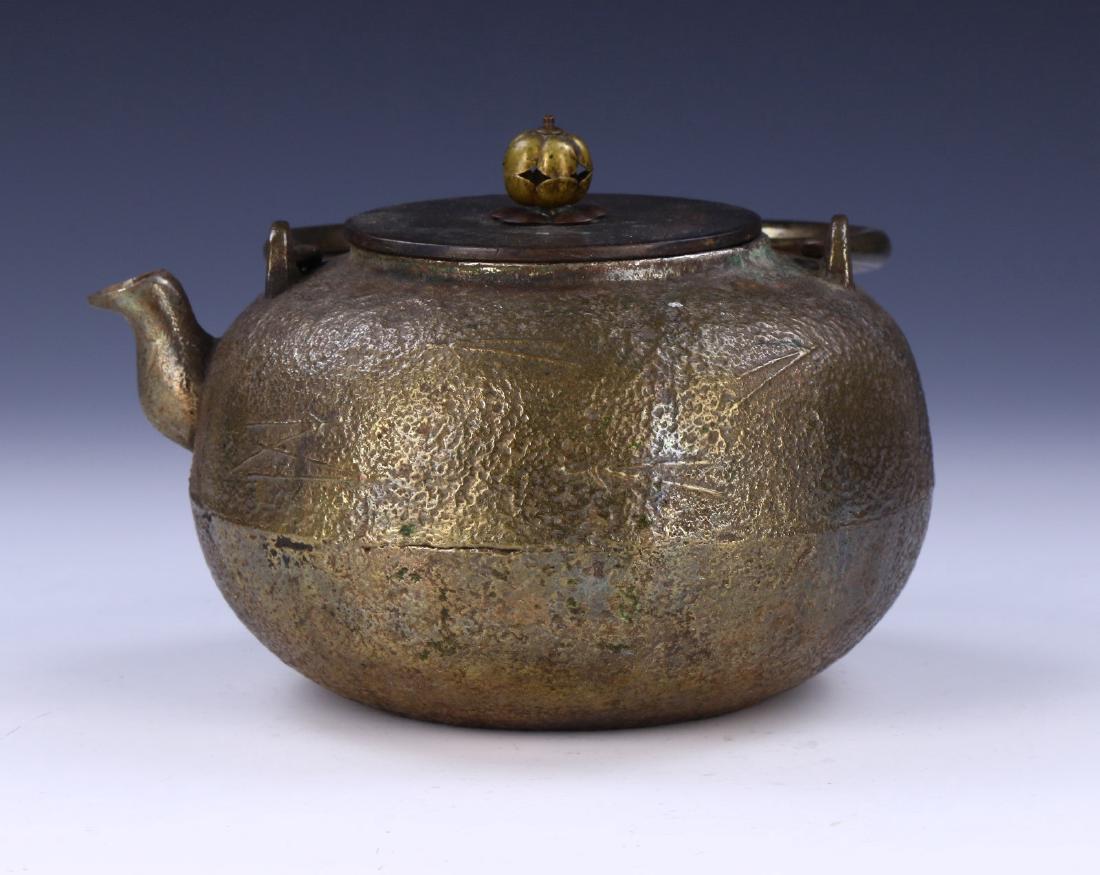 A JAPANESE ANTIQUE IRON TEAPOT: A Japanese Antique Iron Teapot: Of Compressed Globular Form, Rising To A Flat Lid Topped With A Rounded Finial, Of 19Th Century; Size: L: 7" (17.78cm)