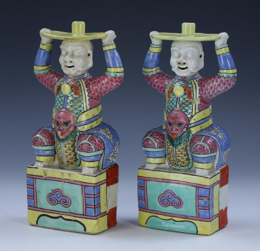 PAIR CHINESE ANTIQUE FAMILLE ROSE PORCELAIN CANDLE: Pair Chinese Antique Famille Rose Porcelain Candle Holders: Well Potted As Seated Figures, Shown Rising From Foursquare Plinths And Draped in Dragon Form Robes, Each With Eyes Closed And Earlobes Elon