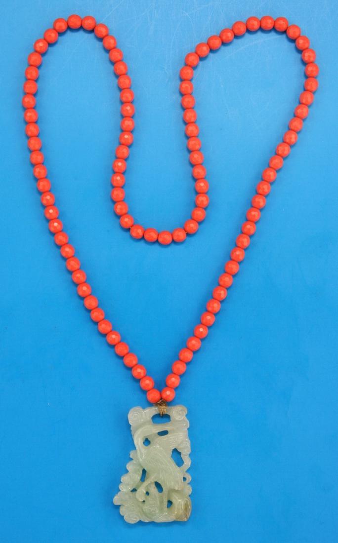 A CORAL BEAD NECKLACE WITH JADEITE PENDANT (1 of 2)