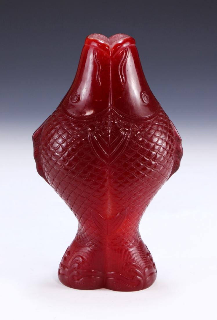 A CHINESE ANTIQUE PEKING GLASS VASE: A Chinese Antique Peking Glass Vase: Finely Carved into A Double Fish Body Design, With Each Mouth Ajar To Form A Cylindrical And Flat Rim; Size: H: 8-1/4" (20.96cm)