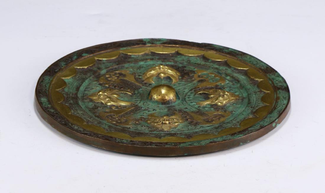 A CHINESE GILT BRONZE MIRROR (1 of 3)