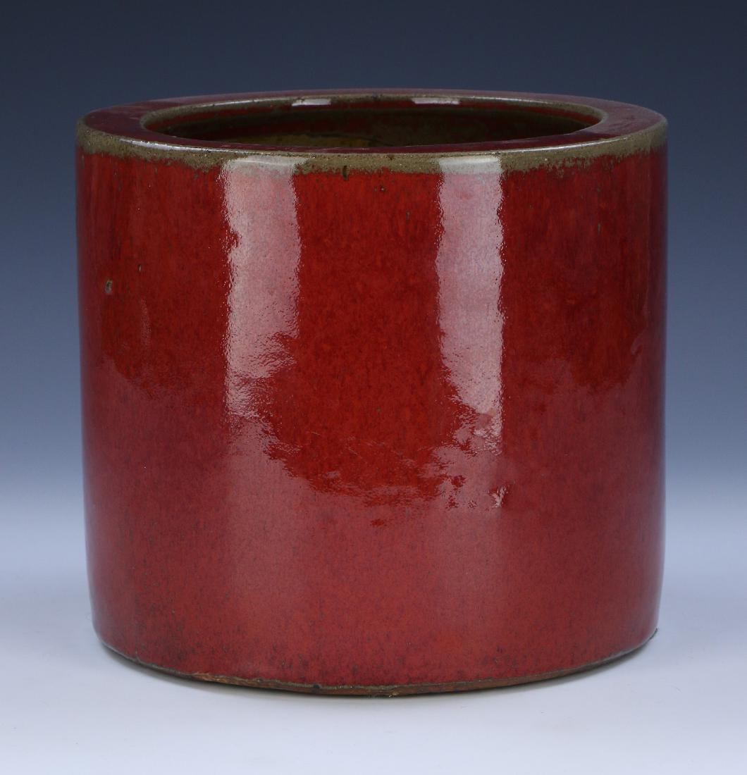 A CHINESE OX BLOOD GLAZED PORCELAIN BRUSH POT: A Chinese Ox Blood Glazed Porcelain Brush Pot: Heavily Potted And Of Cylindrical Form, Exterior Body Evenly Glazed in A Fine Ox Blood Tone; Size: D: 8-1/4" (20.96cm)