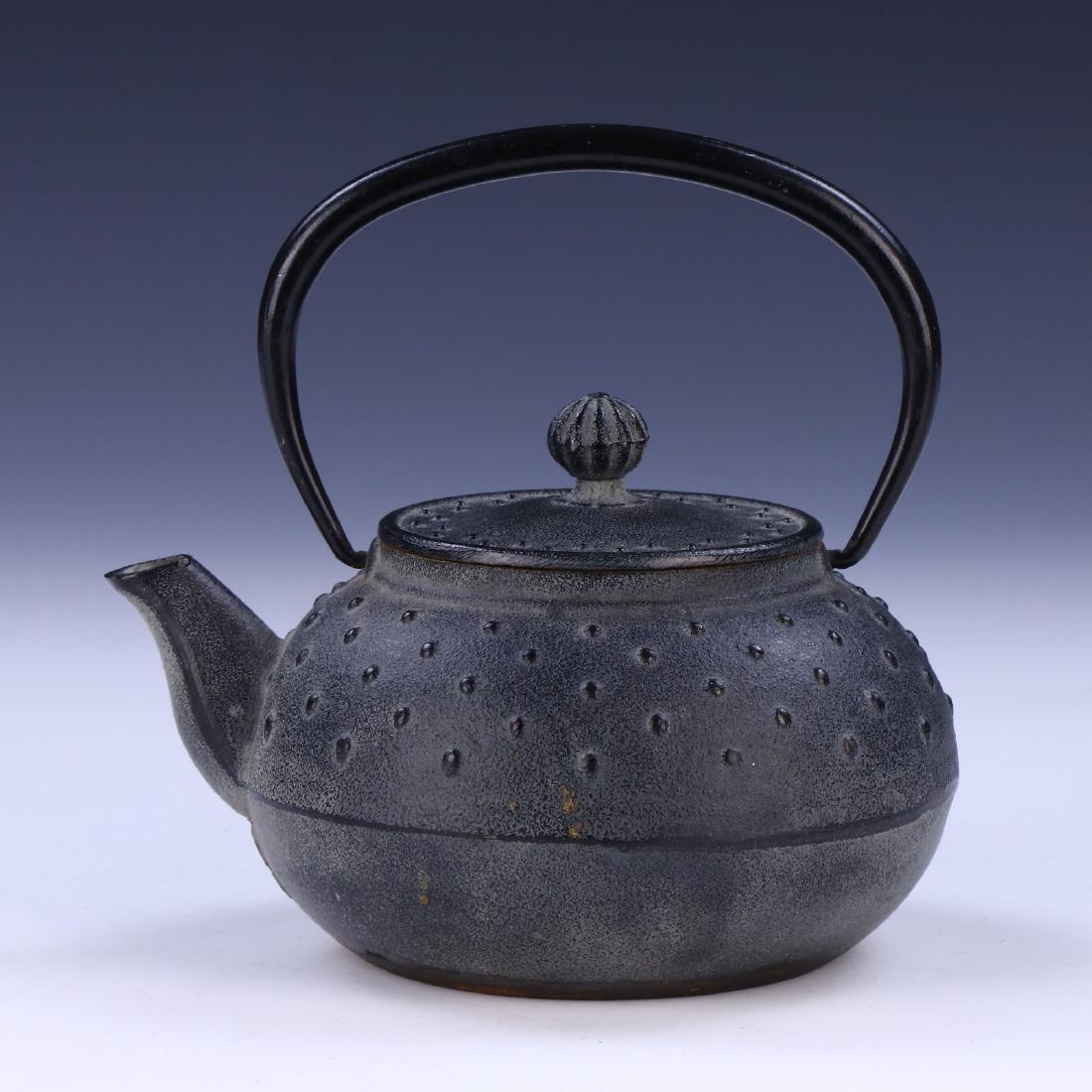 A JAPANESE IRON TEAPOT: A Japanese Iron Teapot; Size: L: 5-1/2" (13.97cm)