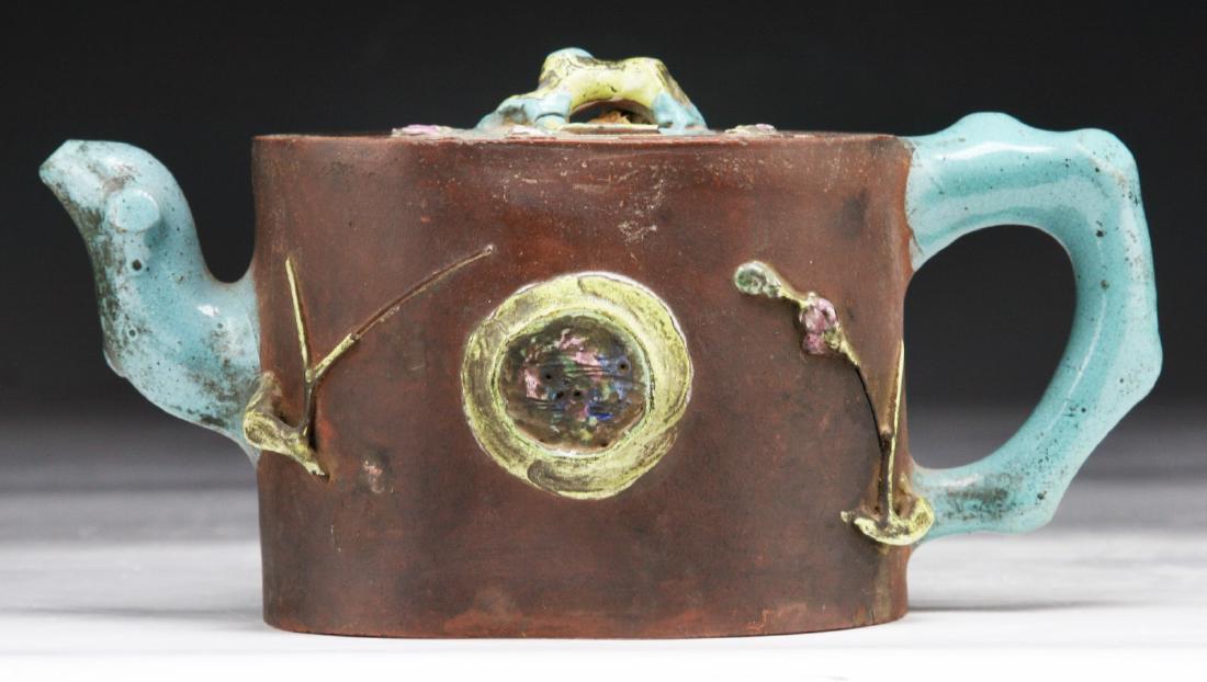A CHINESE YIXING POLYCHROME ZISHA TEAPOT: A Chinese Yixing Polychrome Zisha Teapot: Finely Painted With Blooming Branches On The Sides And Lid, Sign On The Base And Cover; Size: L: 8" (20.32cm)