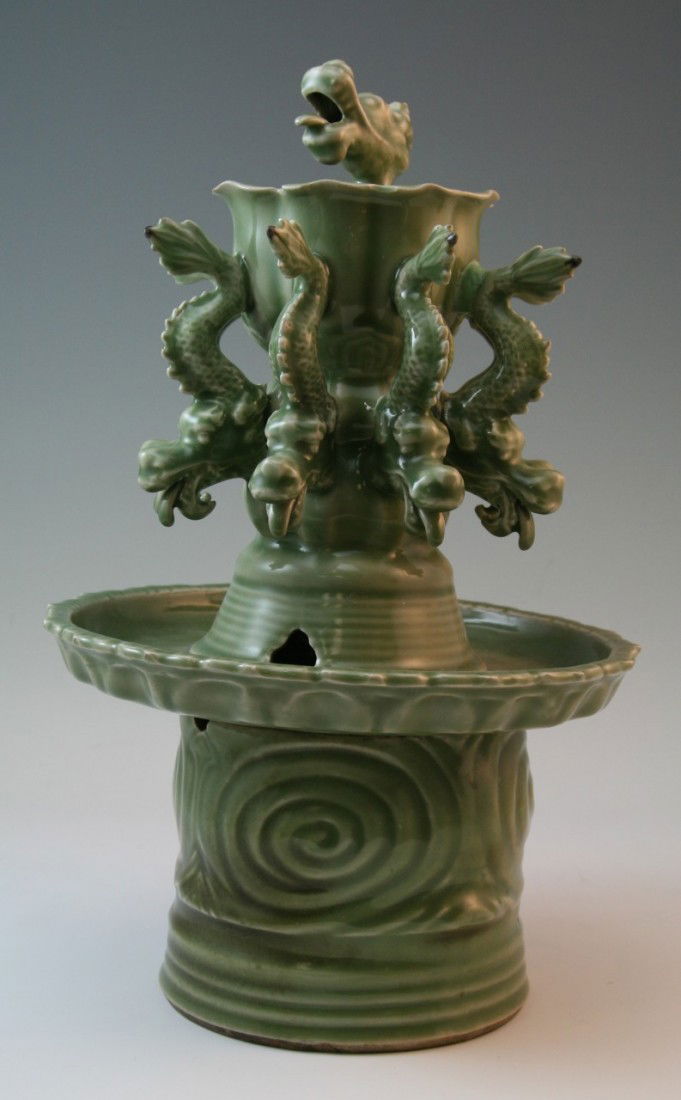 Chinese Longquan style celadon glazed censer: Massive finely hand-carved unusual Chinese sectional Longquan style celadon glazed censer: with one dragon head on the top; together with eight dragons surrounding the cylinder part of the body;; H: 1