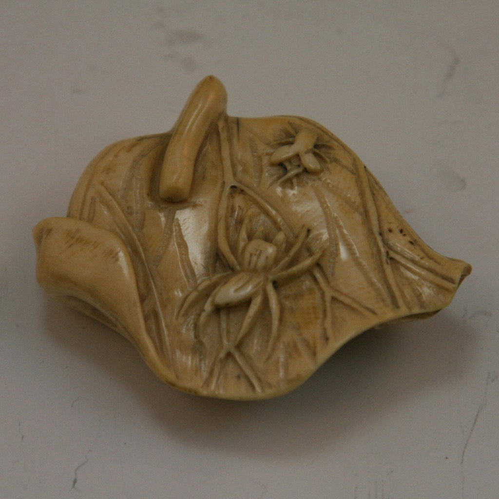 Antique Carved Ivory Netsuke: Antique carved ivory netsuke: one spider crawling towards a fly while both are on a lily pad; H: 1-3/4"