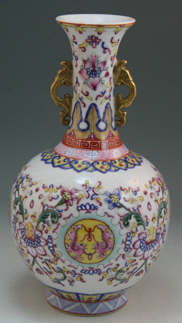 Chinese Minguo Famille Rose Porcelain Bottle Vase: Finely painted and detailed, Chinese Minguo Period famille rose vault-of-Heaven porcelain vase; with two archaistic dragon-shaped ears; allover design of polychrome lotus blossoms and scrolling vines 