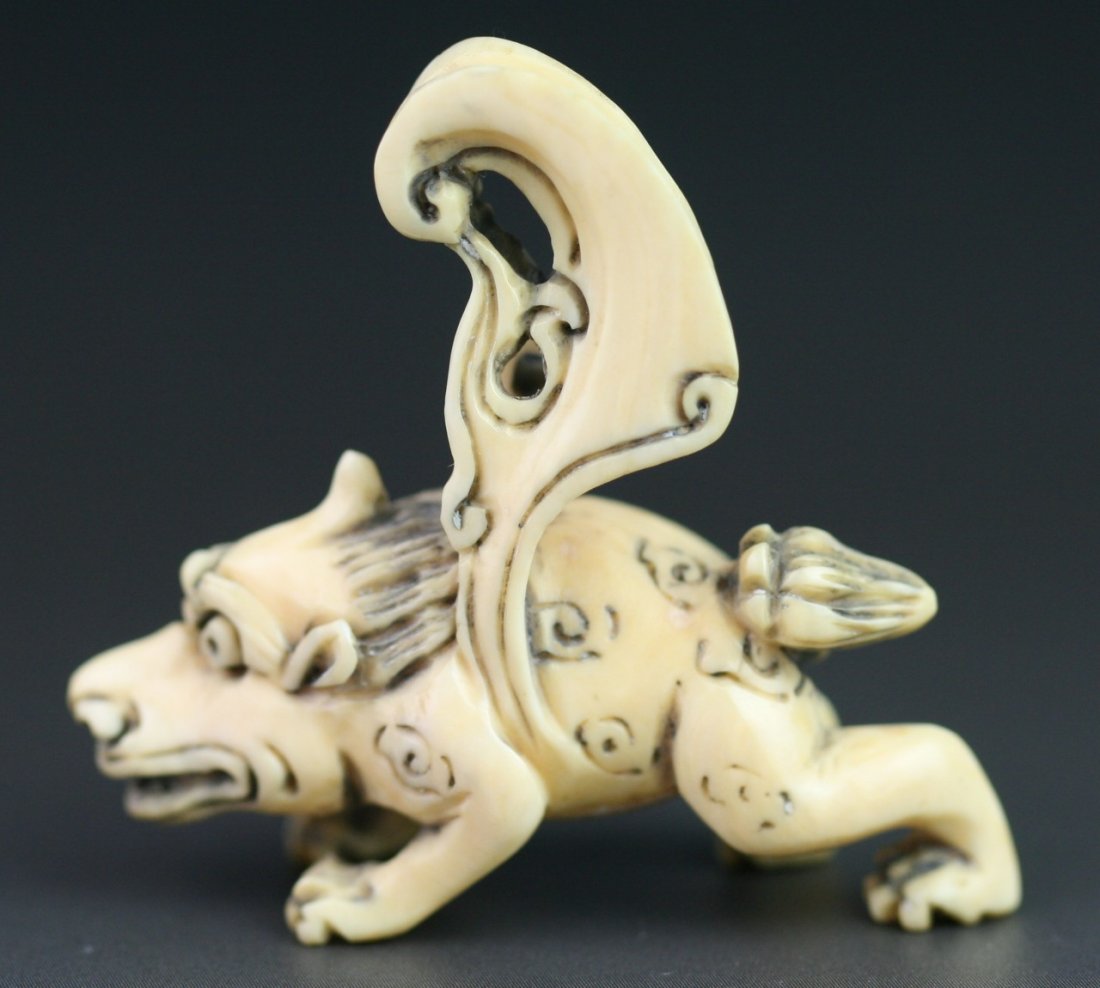 Antique Carved Ivory Netsuke: Auspicious Animal: Antique Carved Ivory Netsuke: auspicious animal with wings with eyes open wide; H: 1-3/4"