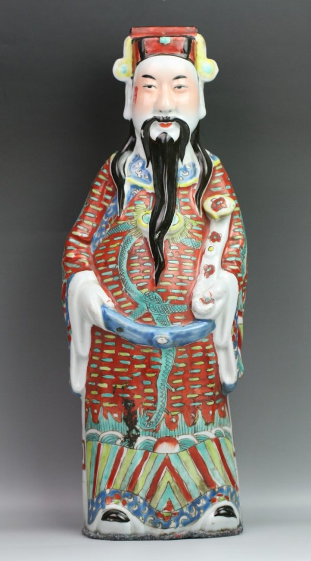 Chinese Minguo Famille Rose Porcelain Statue: Chinese finely painted famille rose porcelain statue: of God of Fortune with headdress standing in red robes decorated with sea waves; holding a ruyi in his left hand; with hallmark of Mao Jisheng on 