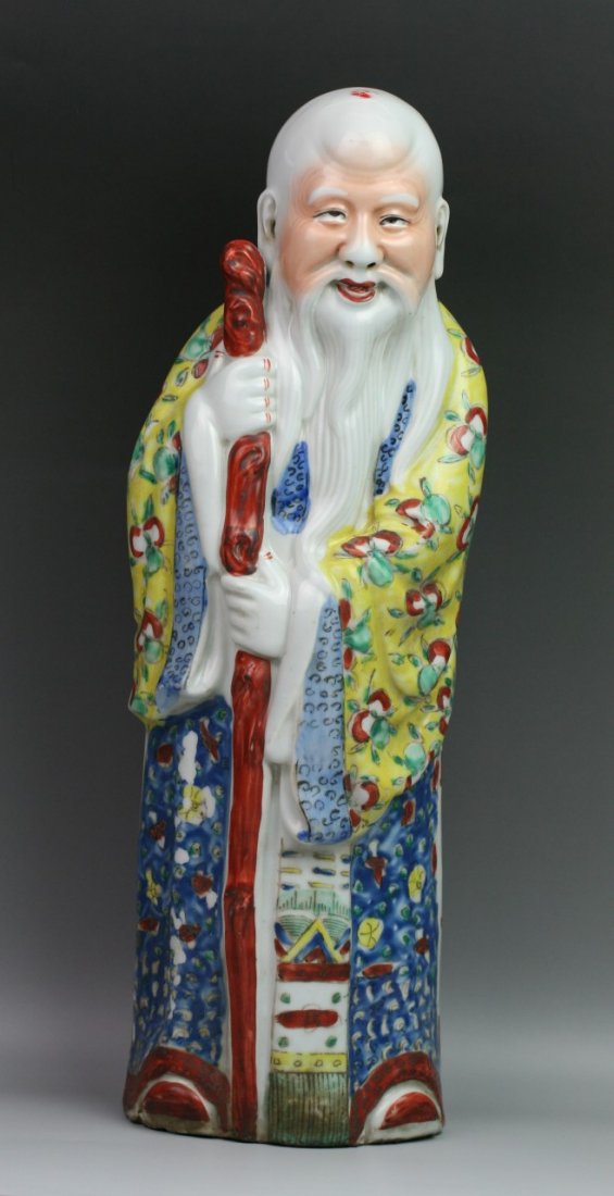 Chinese Minguo Famille Rose Porcelain Statue: Chinese finely painted famille rose porcelain statue: of Shoulao Longevity God with an enormous head standing in draped robes fully decorated with peaches and other symbols; holding a long stick in ha