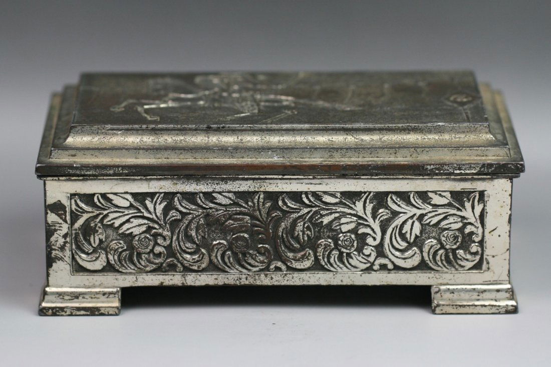 Fine Japanese Antique Silvered Trinket Box: Fine Japanese Silvered Trinket Box: with the design of a warrior riding on a horse carrying bow in his hand: with scrolling vines on four sides: late 19th century; Size: L: 6-1/4" H: 2-1/2"