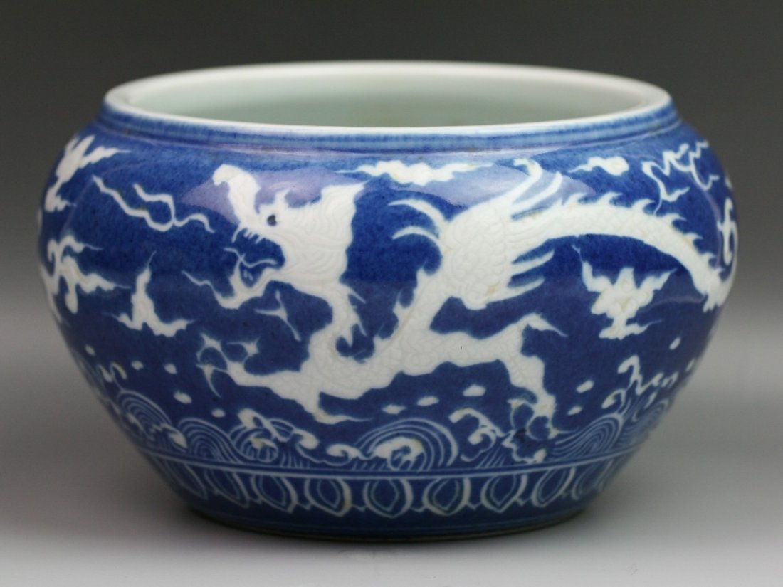 Chinese Ming Style Blue & White Porcelain Jar: Chinese Ming-style blue & white porcelain jar: exterior with the design of dragon flying in the turbulent cloud scrolls above sea waves: interior with the design of flower with Buddhist symbols: with 