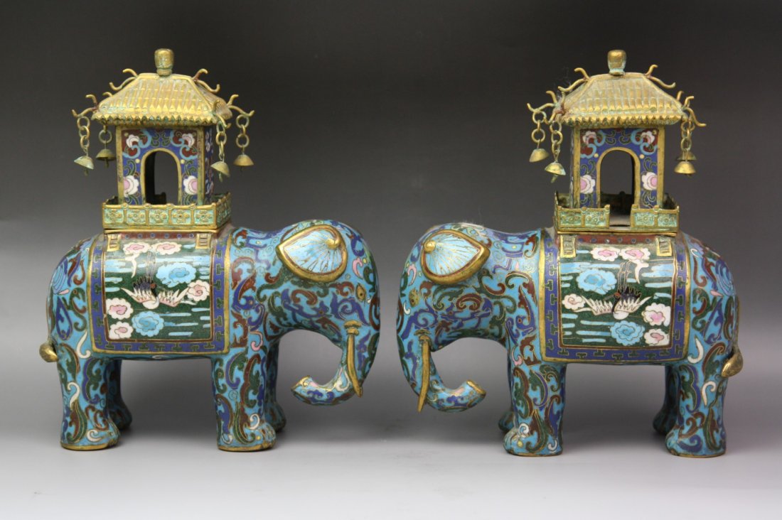A Fine Pair Of Gilt Cloisonne Enamel Elephants: A Fine Pair of Gilt-Bronze Cloisonne Enamel Elephants: Looking with heads lowered slightly to the left and right, the bodies decorated with a dark blue, green and red enamel, the lowered trunks looped