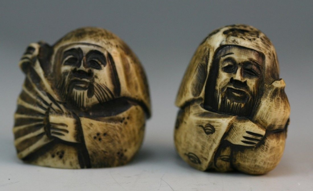Pair Antique Ivory Netsuke: Figures: Pair carved ivory netsuke: one man holding a fan to the side of his face with both hands; the other is a man is standing with a gourd in his hands; Size: 2" (high)