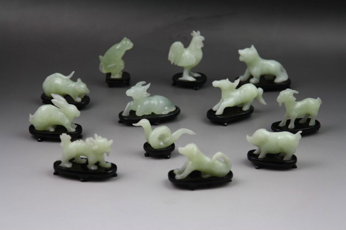 Set of Jade Carvings of Twelve Chinese Zodiac: Set of Jade Carvings of Twelve Chinese Zodiac: carved from the stone of semi-translucent pale green tone, all presented on wood stands; Size: Chicken on stand H: 3-1/4"